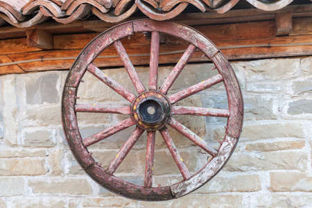 old wagon wheel on the wallの写真素材