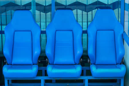 Empty coach and reserves blue bench on a football stadiumの写真素材