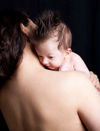 Newborn baby on his Mothers shoulderの写真素材