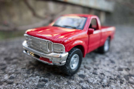 Red pick up truck toy on the road. Shallow depth of fieldの写真素材