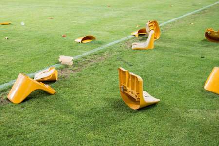 broken plastic seats after match on stadium. vandalismの写真素材
