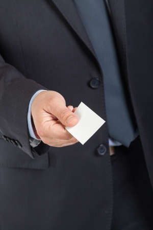 Business man handing a blank business cardの写真素材