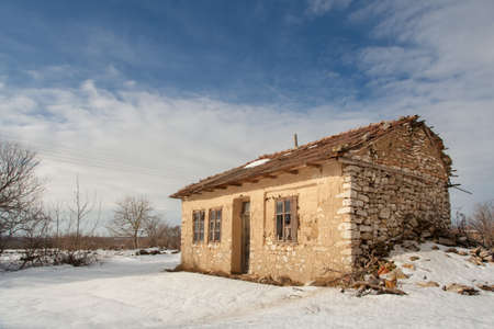 Old abandoned village house on winterの写真素材