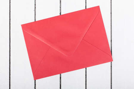 red envelope on white wooden backgroundの写真素材