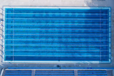 Top view, bird eye view of swimming pool with marked lanes and starting platform.の写真素材