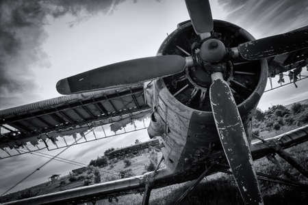 Old airplane on field in black and white