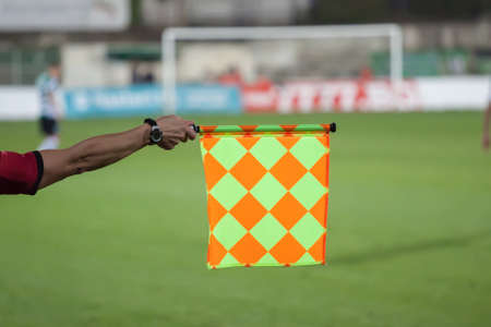 Soccer referee hold the flag. Offside trapの写真素材