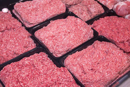 Minced meat in the store. Fresh raw mince at butcher shopの写真素材