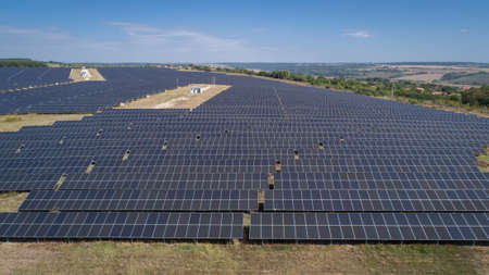 Aerial shot of photovoltaics solar farm. Solar farm power station from above. Ecological renewable...