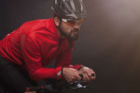 Cyclist in red jacket riding the bike. Extreme sport concept.