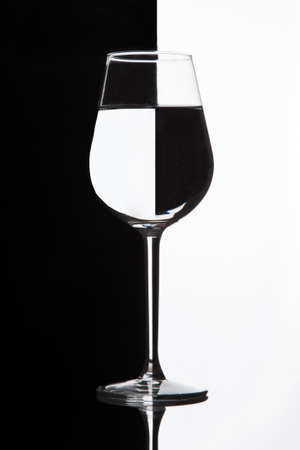 Wine glass with domino effect. Wineglass with liquid - refraction.の写真素材