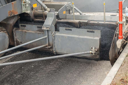 Close up asphalt laying machine. Asphalt paver. Tarmac road laying machine. Asphalt spreader. Road...