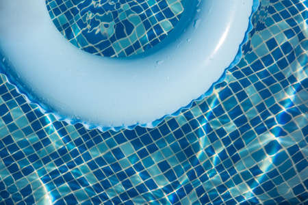 Blue pool float, ring floating in a refreshing blue swimming poolの写真素材