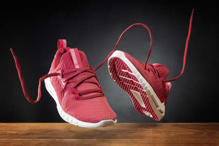 Flying in the air pink running sports shoes. Abstract shopping concept. Levitation sports shoes with...