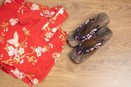 Japanese traditional geta sandal and traditional clothes of Kimono, Yukata on wooden floor.