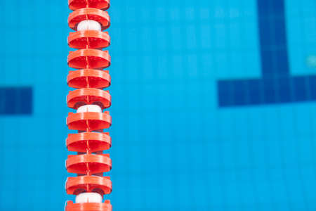 Close up of swim lane in swimming pool. Plastic swimming pool floating wave-breaking laneの写真素材