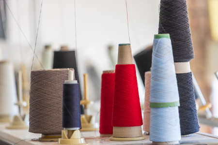 Spools of thread in the sewing equipment in fabric industry. Sewing production.の写真素材