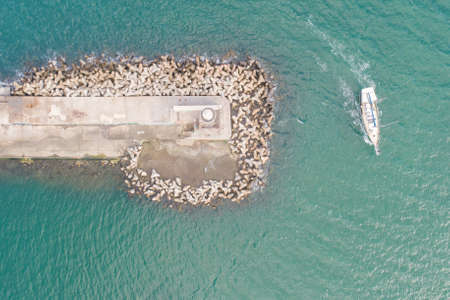 Top down view of lighthouse and passing yacht. Varna, Bulgaria. Varna is the sea capital of Bulgaria.の写真素材