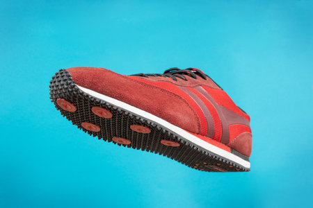 Sports shoe on blue background. Sneaker or trainer. Fitness, sport, training concept.