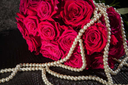 Beautiful pink roses and white pearls. Background for valentines and woman day. Wedding decorationの写真素材