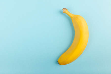 Yellow banana on pastel blue background. Top view.の写真素材