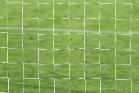 Football, soccer goal net with green grass background