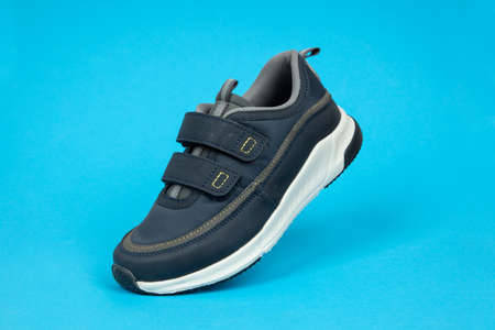 Running sports shoe on blue background. Running shoe, sneaker or trainer. Athletic shoe. fitness,...