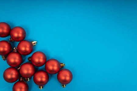 Red christmas balls on blue background. Christmas holiday celebration conceptの写真素材