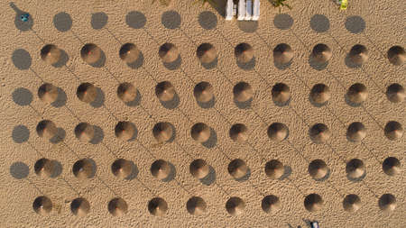 Top down view of beach with straw umbrellas.の写真素材