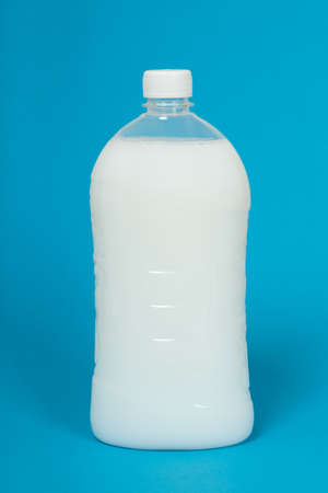 Plastic Bottle with liquid soap on a blue background