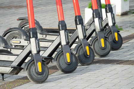 Row of electric scooters for public share. Electric urban transportation