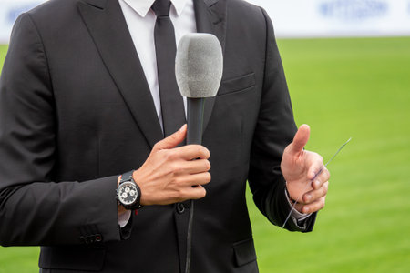 News journalist with microphone interviewingの写真素材