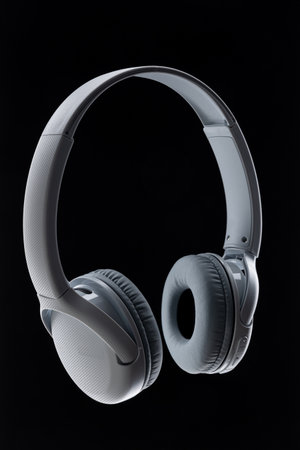 Wireless white headphones on black background. Music concept. Earphones on black background.