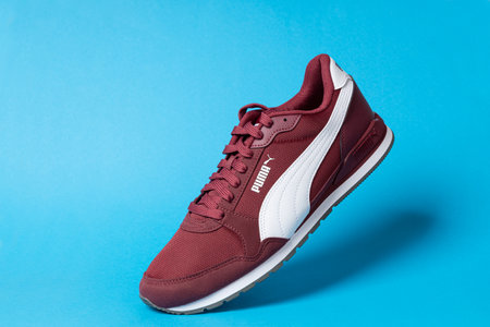 Varna , Bulgaria - JANUARY 17, 2023. PUMA sport shoe, on blue background. Puma, a major German...