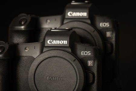 Varna, Bulgaria - September 8, 2021: Two Canon EOS R cameras on a black background. The new mirroless full frame Canon cameraのeditorial素材