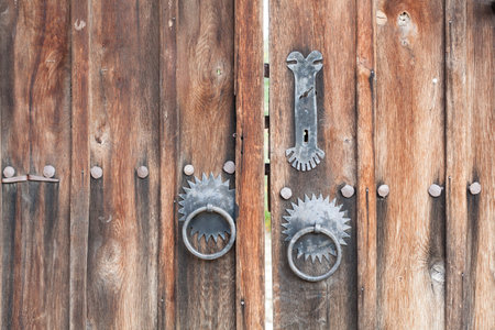 Old wooden doors with metal door handle, knocker. Wooden doors with metal hardwareの写真素材