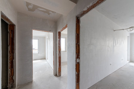 New empty rooms under construction. Plaster walls. New home. Concrete walls. Interior renovation.の写真素材