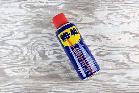 VARNA, BULGARIA - MAY 19, 2022: WD-40 on wooden background. Multi use product protects metal from...