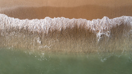 Top view landscape scene of waves crashing on empty tropical beach
