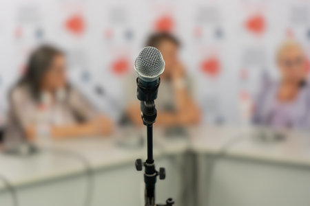 Close up of microphone in conference room, business people forum, meeting, training, learning, coaching concept.の写真素材