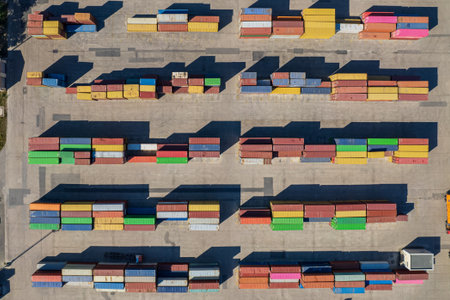 Top down view of colorful containers piles in port container terminal, industrial cargo harborの写真素材