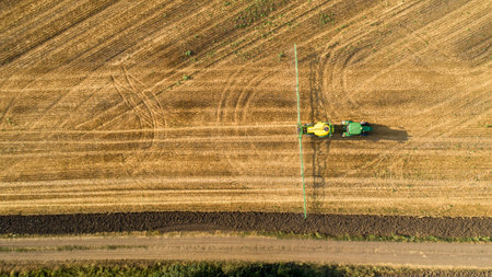Top down view of farming tractor spraying on field. Protection of plants.の写真素材