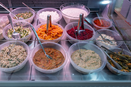 Take-out food in showcase window. Food for home. Saladsの写真素材