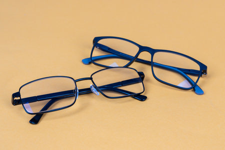 Modern Black Eyeglasses: Two Pairs with Different Frames (Metal & Plastic). Modern Eyewear Fashion, Vision Correction, Optical Accessories Concept for Retail, Lifestyle, and Healthcare Useの写真素材