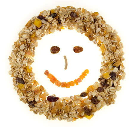 Breakfast cereal and muesli shaped in a happy face against a white backgroundの写真素材