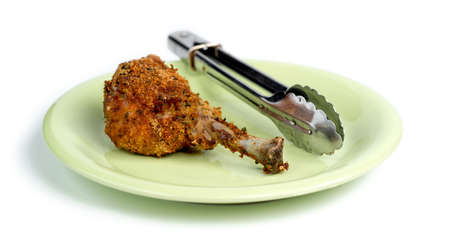 Breaded skinless fried chicken on green plate against white backgroundの写真素材