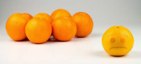 Sad orange ostracized by darker, taller oranges.の写真素材