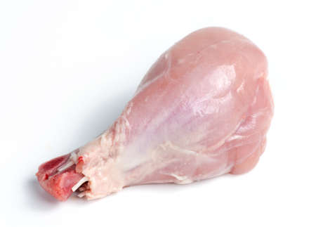 Fresh skinless chicken drumstick leg against whiteの写真素材