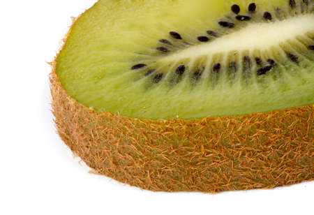 Closeup of slice of kiwi fruit against white backgroundの写真素材