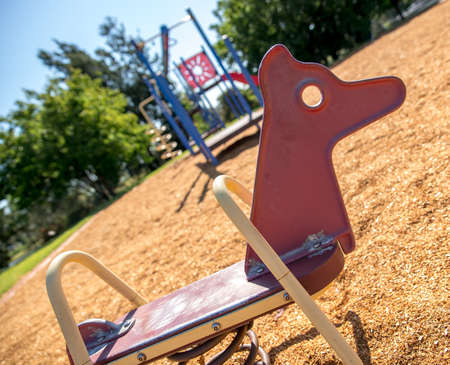 Red rocking horse in summer with children